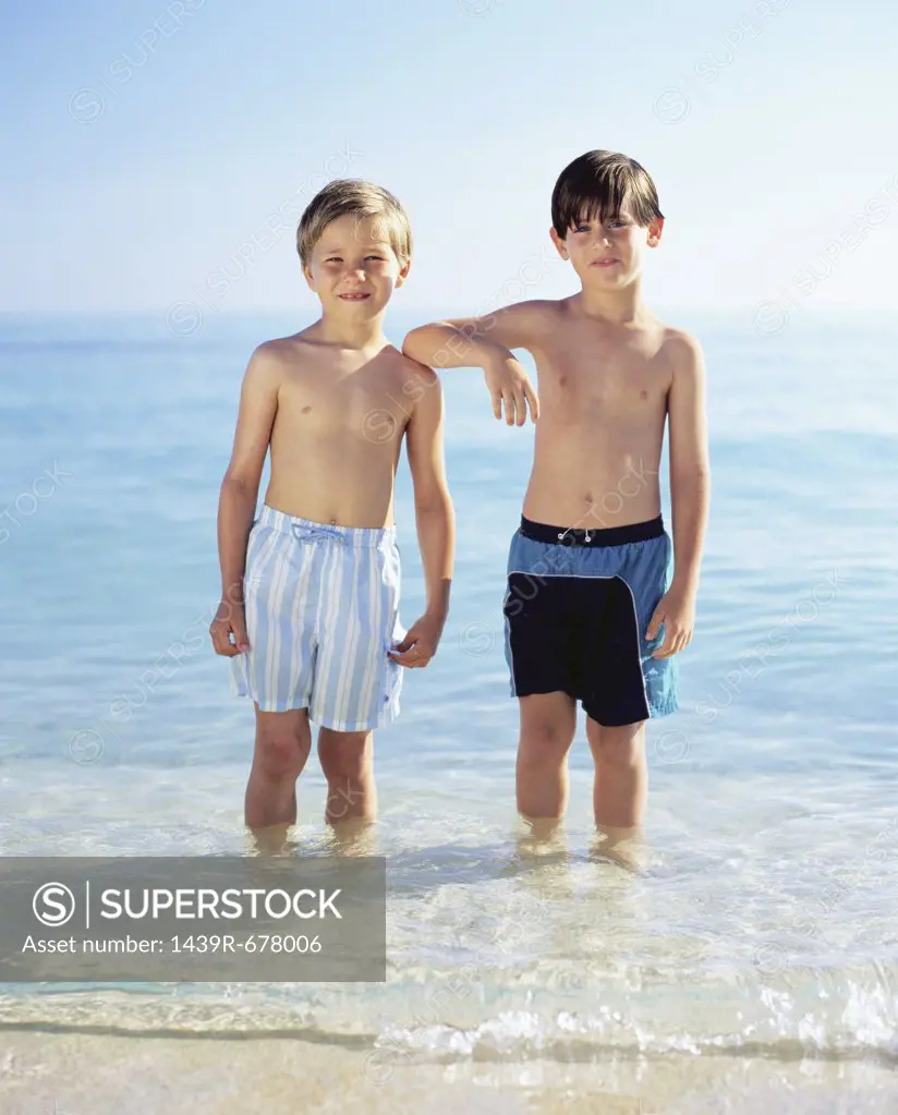Two boys standing in the sea