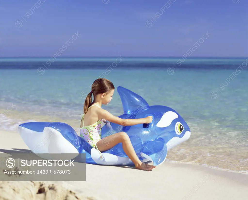 Girl on inflatable whale