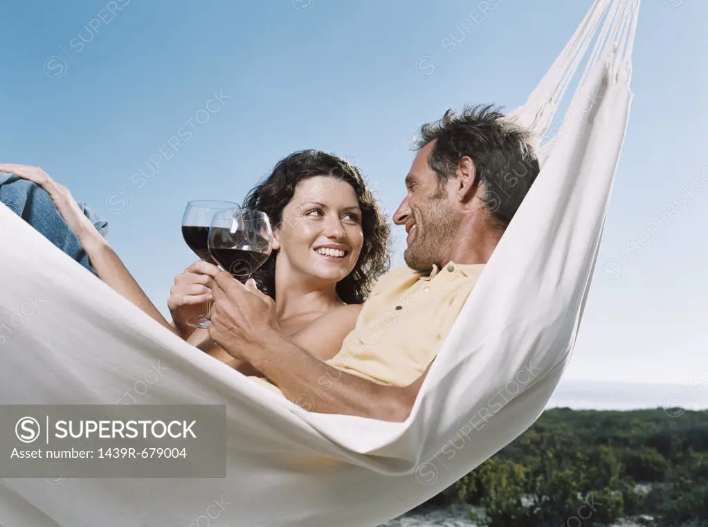 Couple in a hammock with wine
