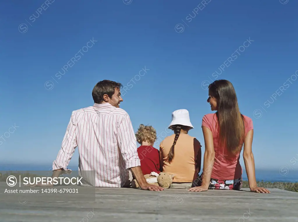 Family sitting on a deck