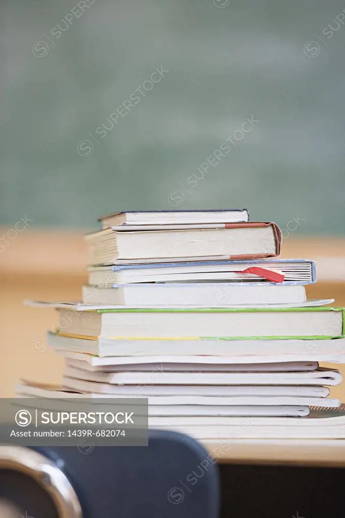 Stack of textbooks in classroom