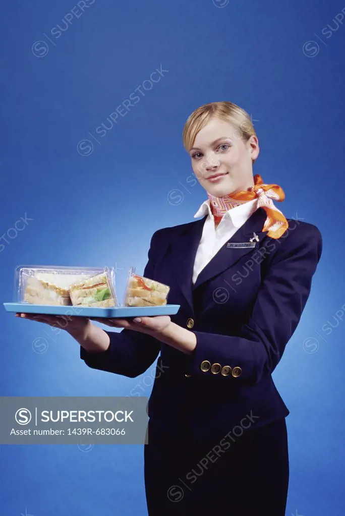 Air hostess holding a tray of sandwiches