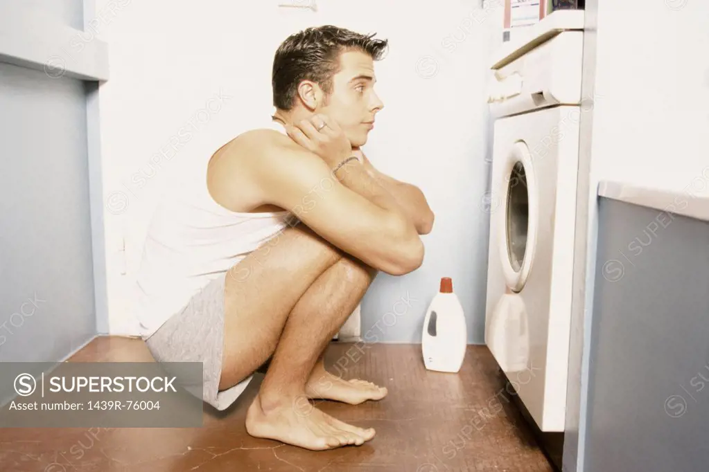 Man watching washing machine