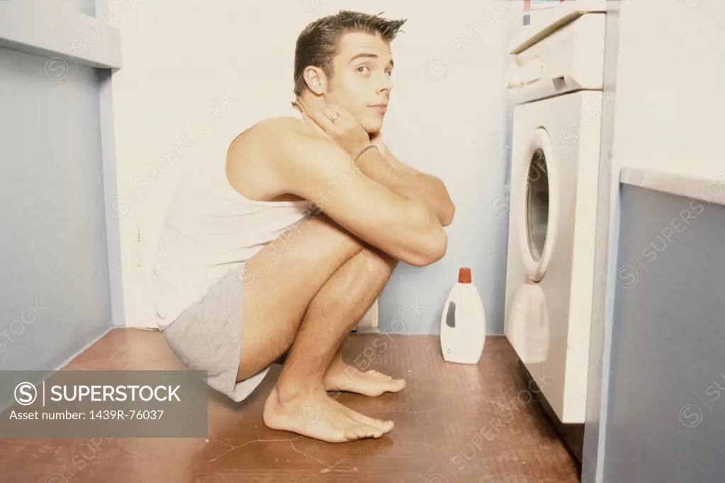 Man in front of washing machine