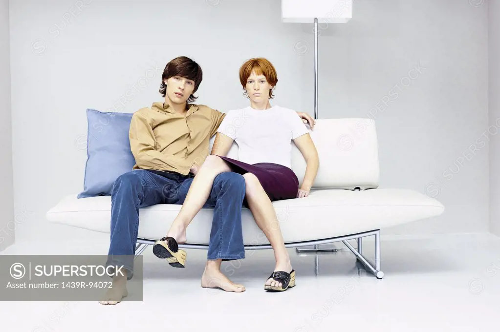 Man and woman close together on modern sofa