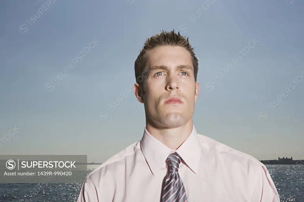 Businessman standing near the sea