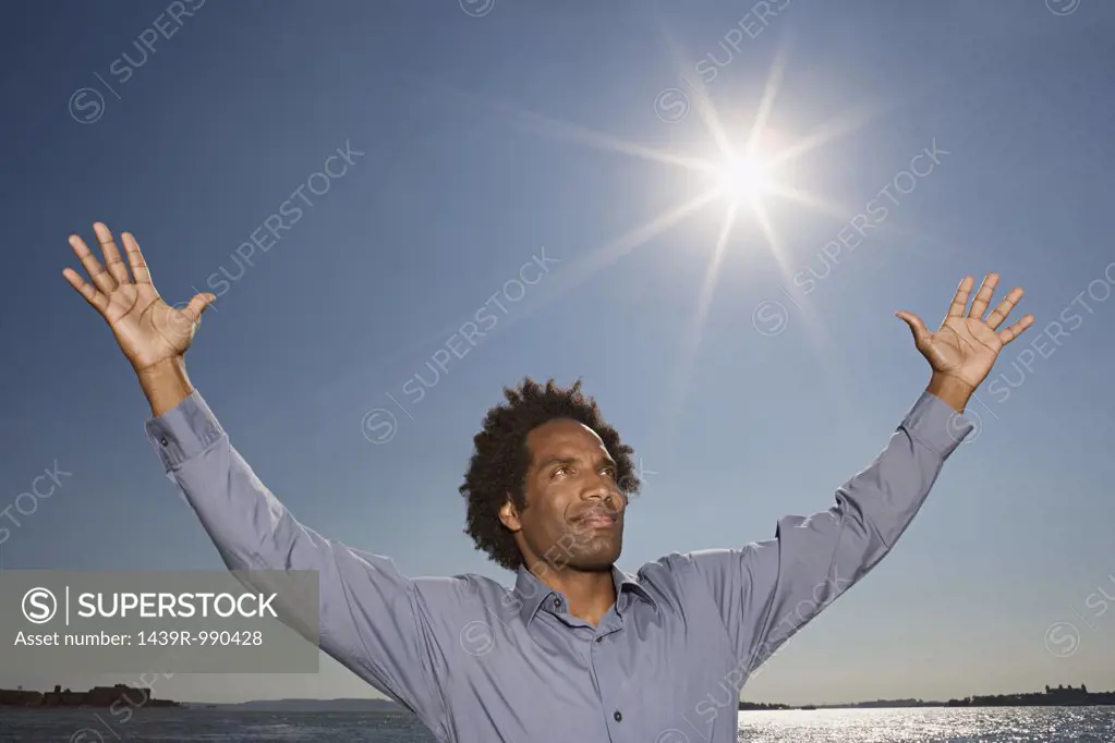 Man with his arms raised to the sky