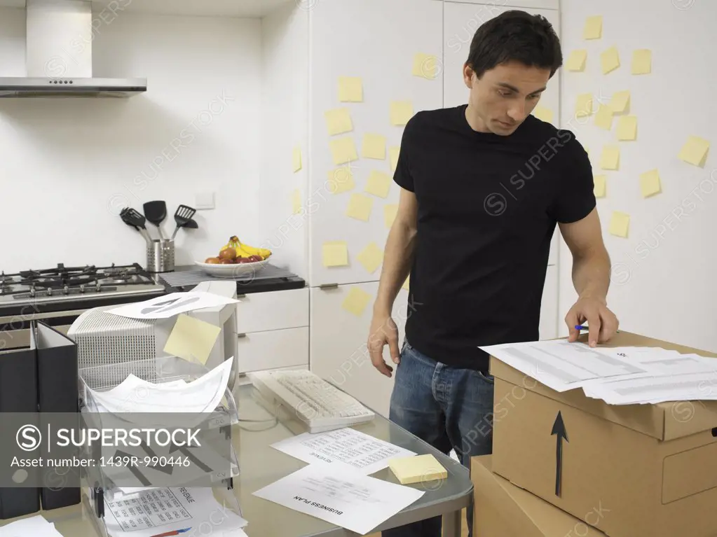 Man with office in the kitchen