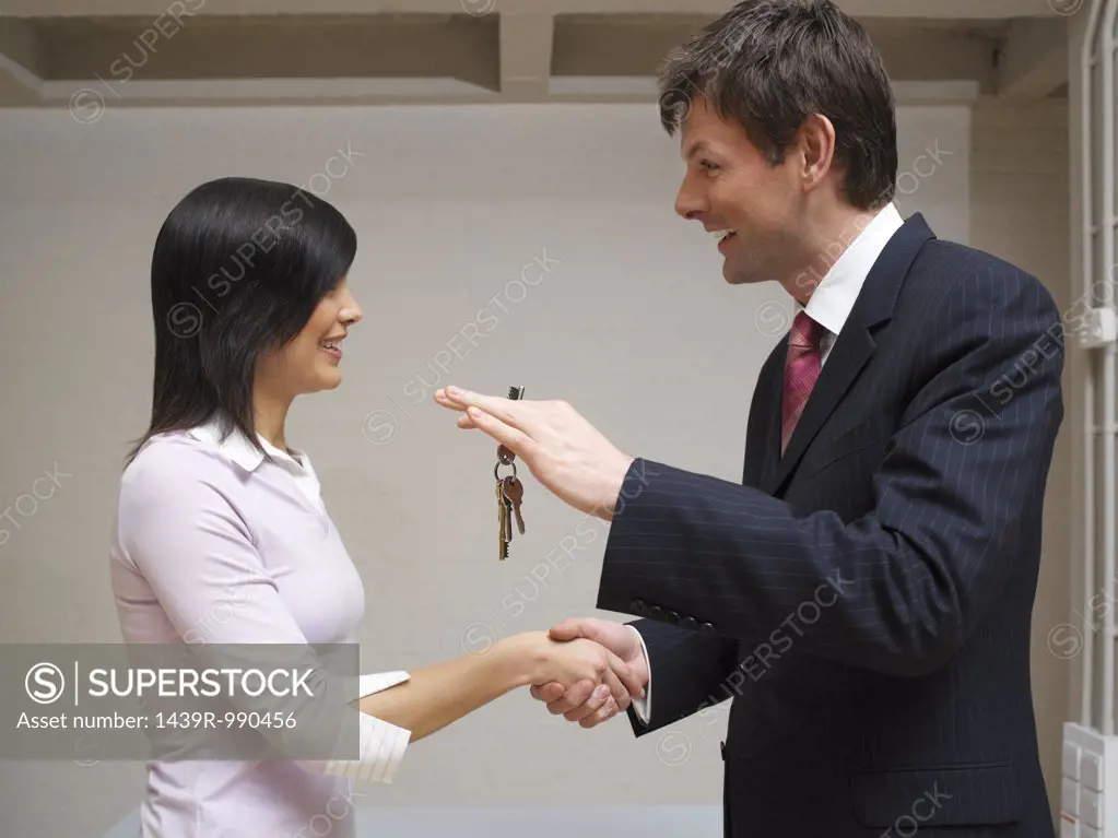 Man and woman exchanging keys