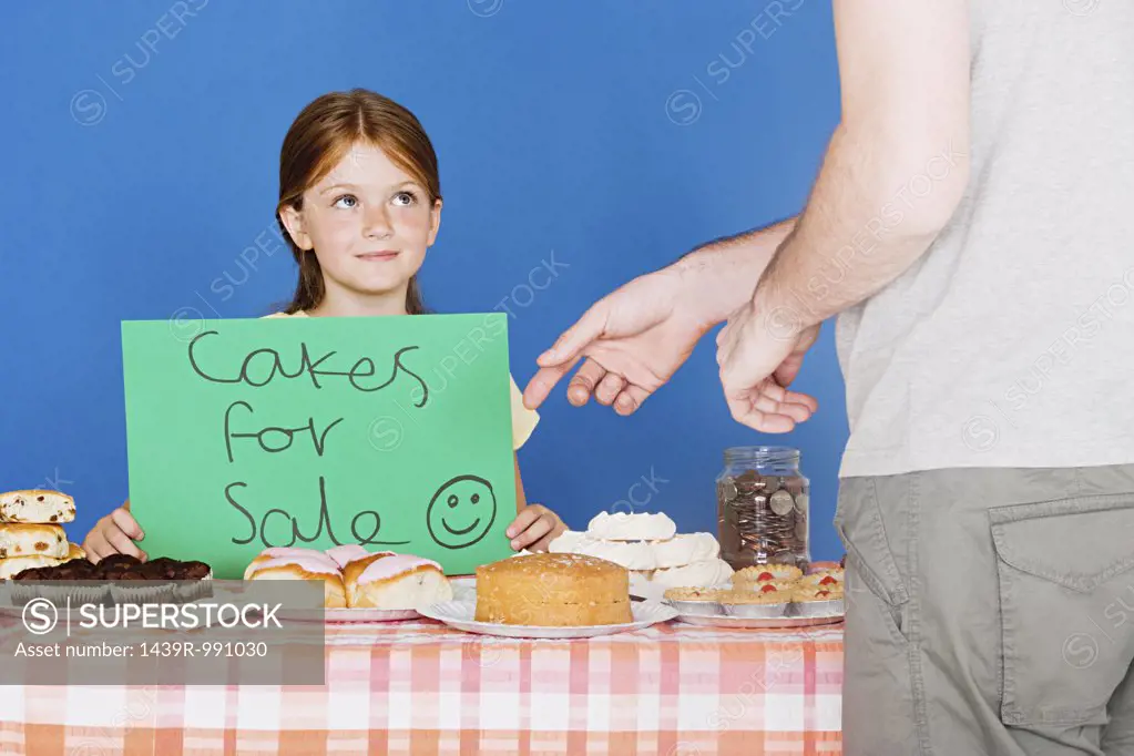Man buying cake from girl