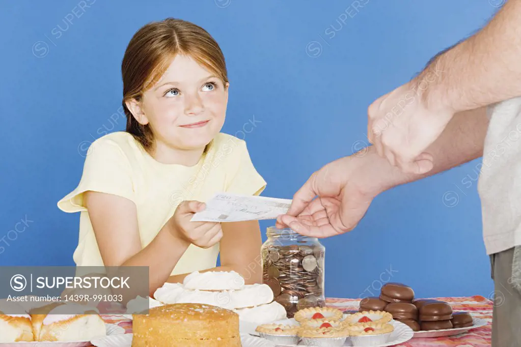 Man buying cake from girl