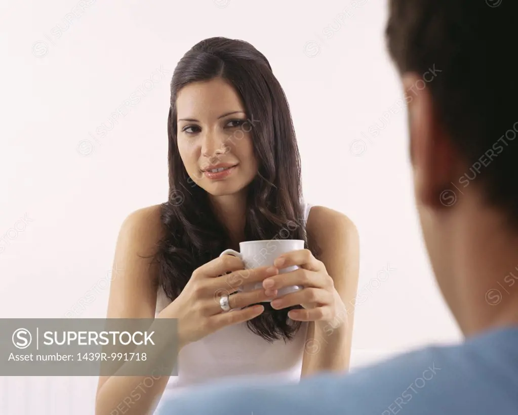Woman having coffee with man