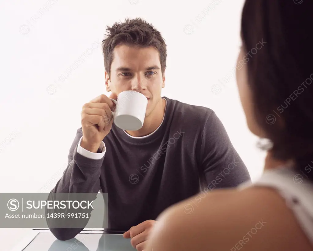 Man having coffee with woman