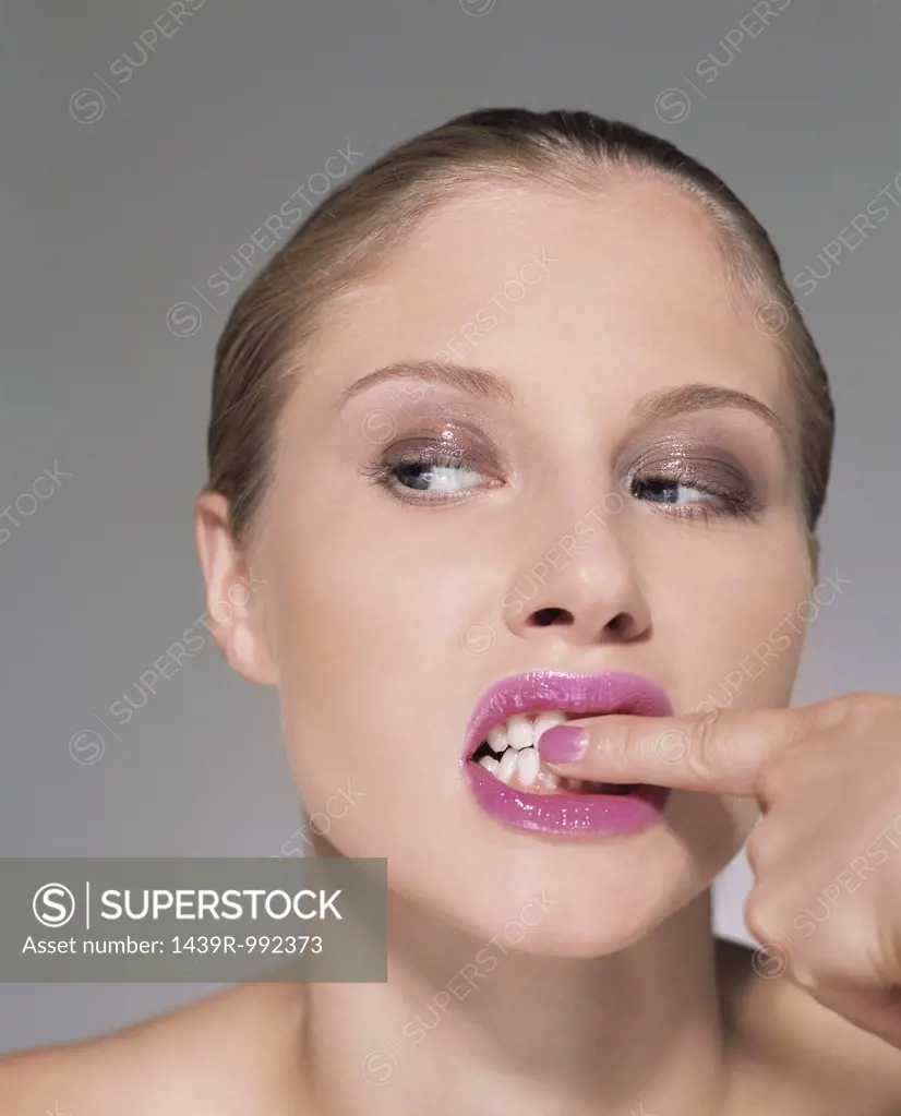 Woman rubbing her teeth