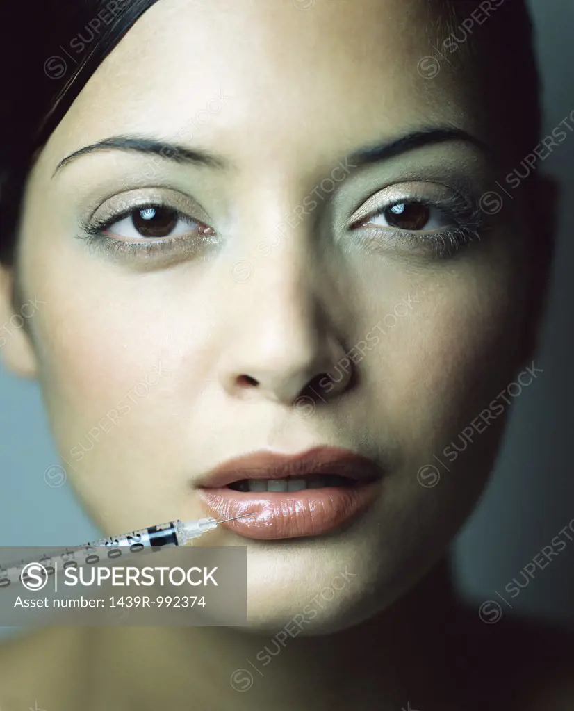 Woman having injection in her lip