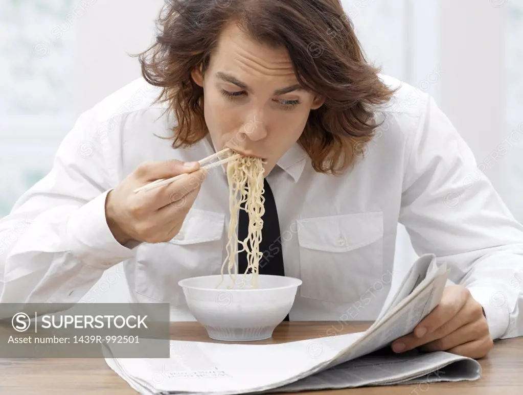 Office worker eating spaghetti