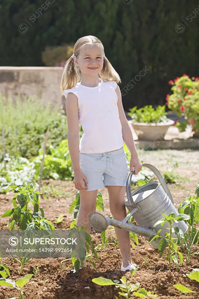 Girl holding watering can