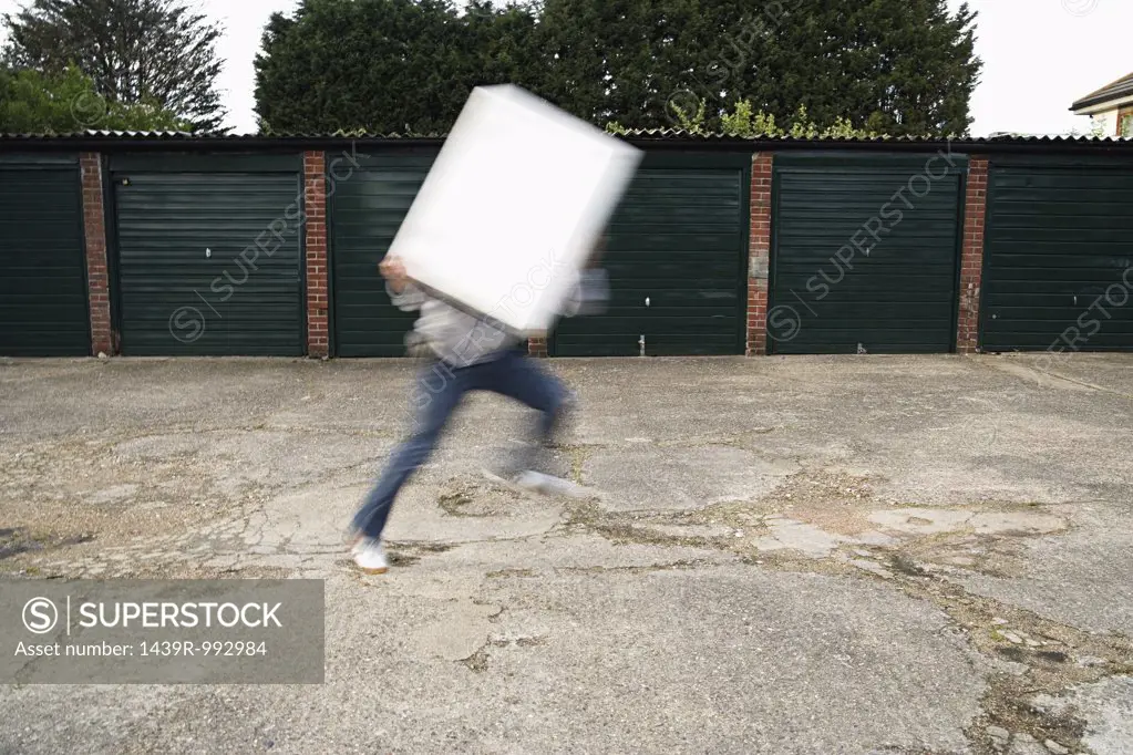 Man holding board and running
