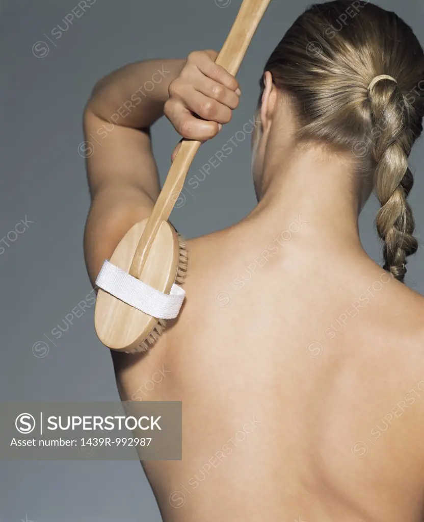 Woman using back brush