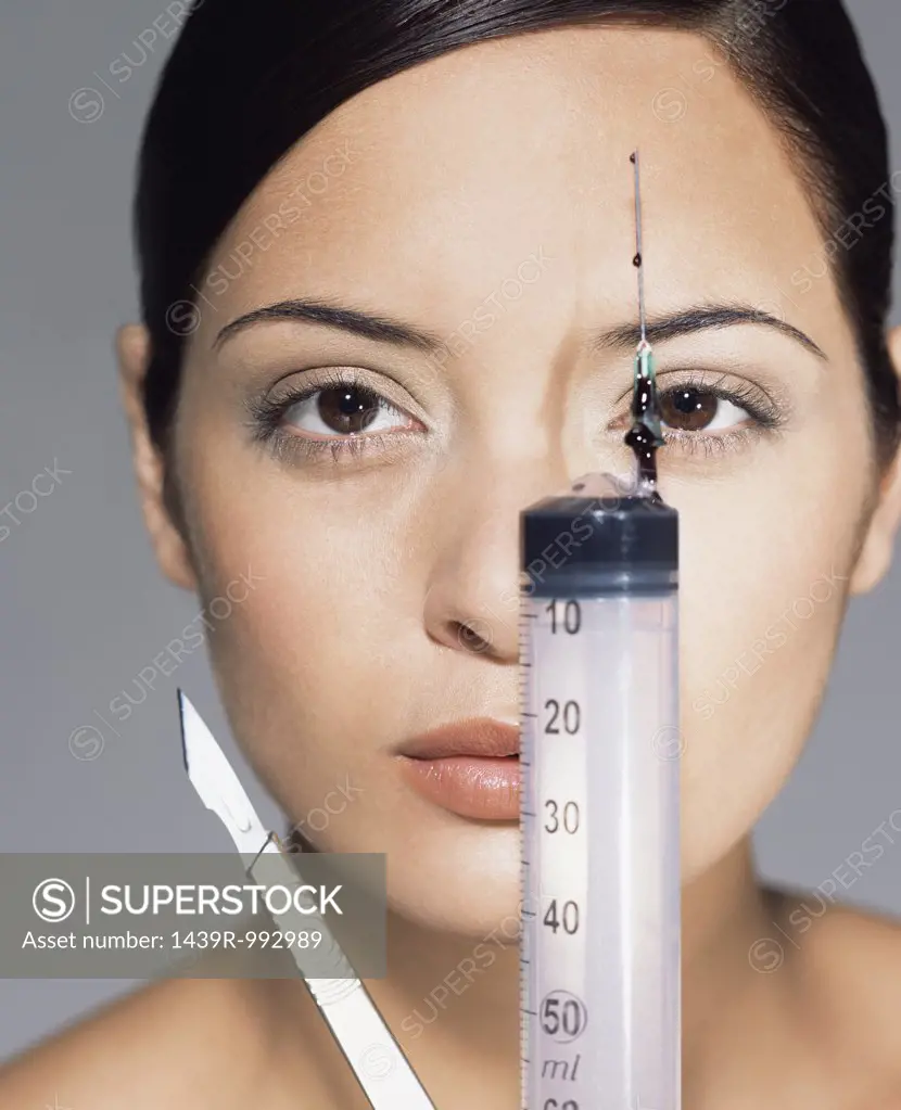 Woman with syringe and scalpel