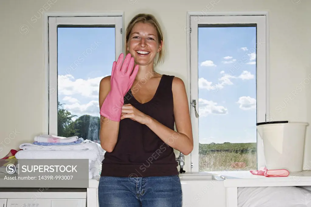 Woman putting on rubber glove