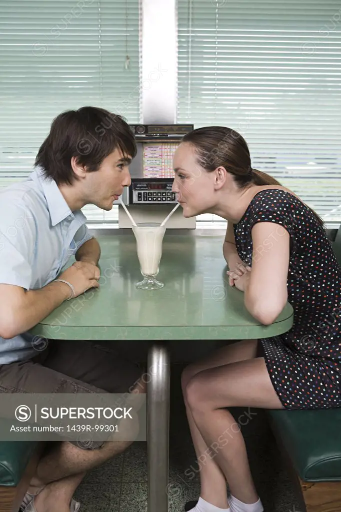 Young couple drinking a milkshake