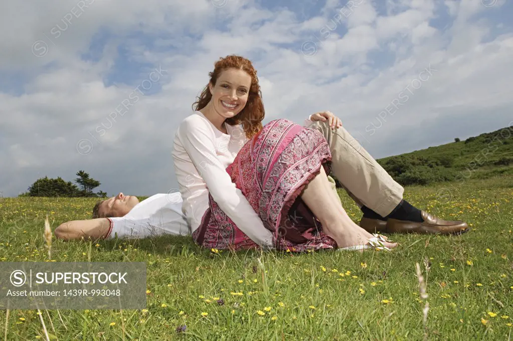 Couple resting in a field