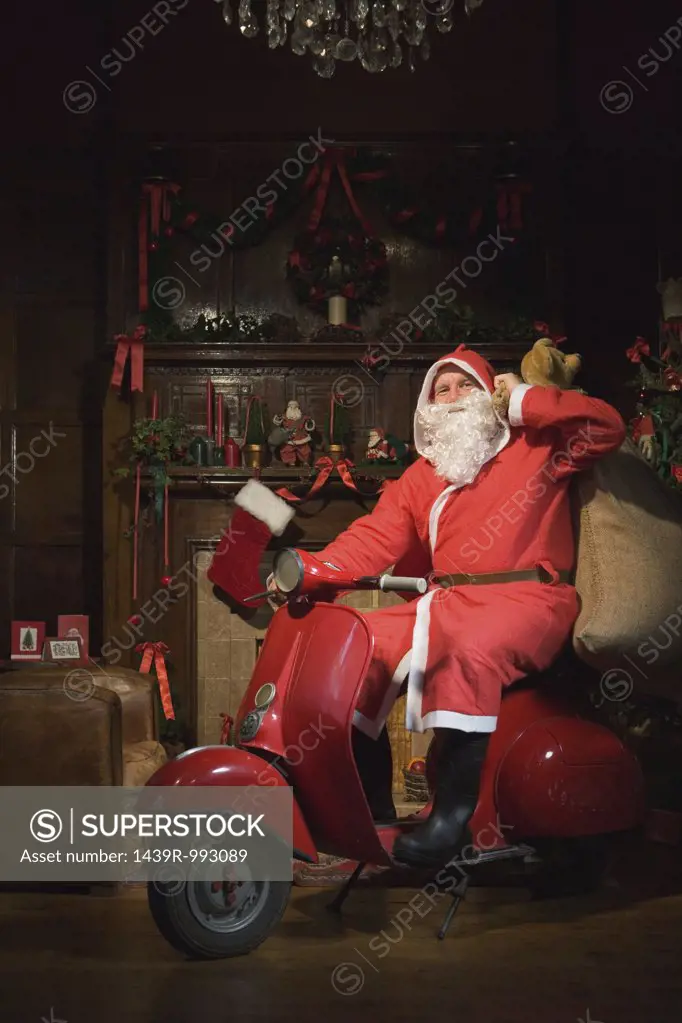 Santa claus riding a moped