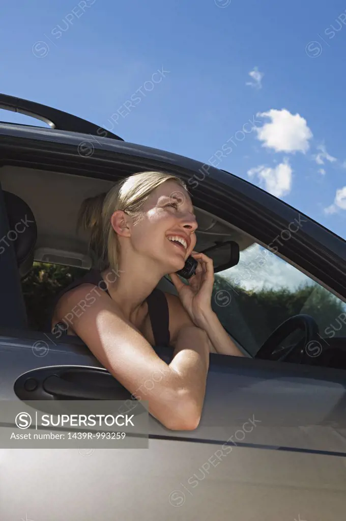 Woman in car using mobile phone 