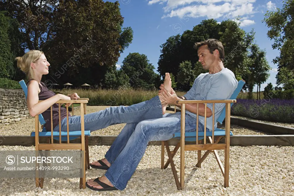Man massaging his girlfriend's feet