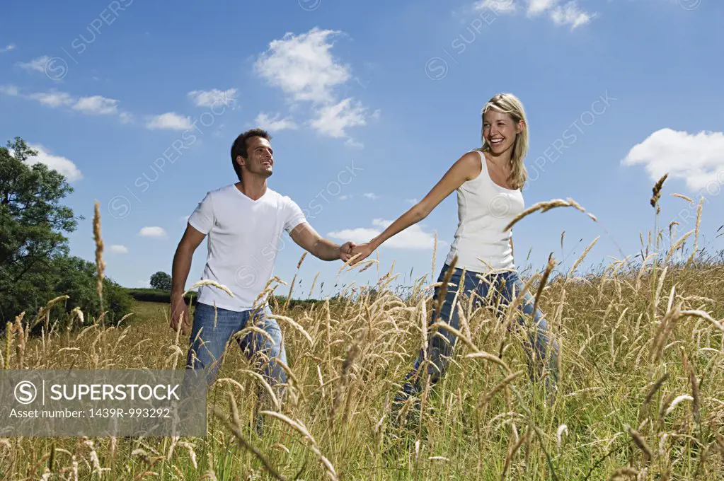 Couple walking through field