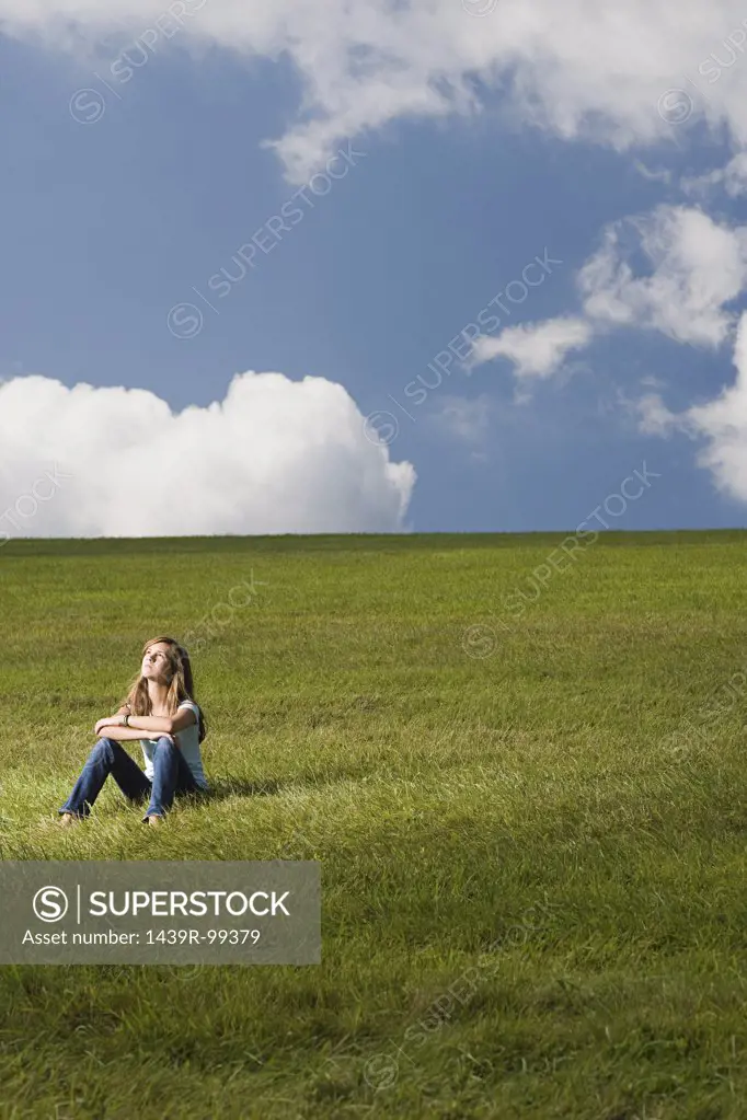 Girl sitting in a field