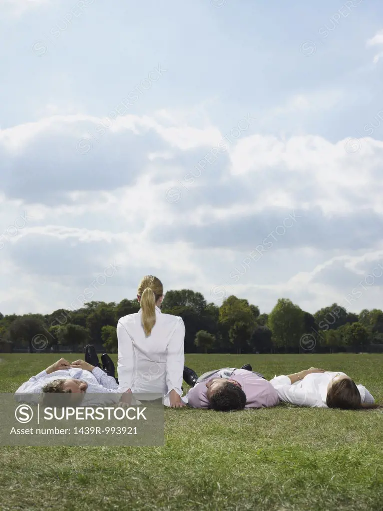 Office workers relaxing in a field