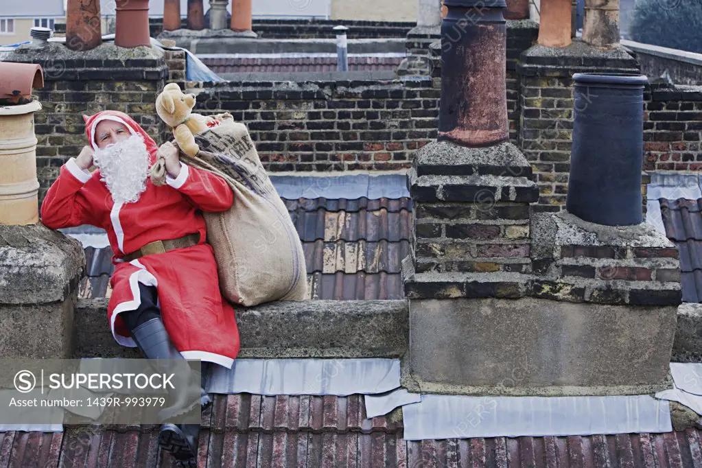 Santa claus sitting on a roof