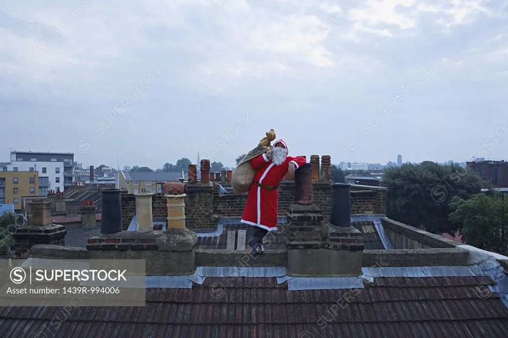 Santa claus standing on a roof