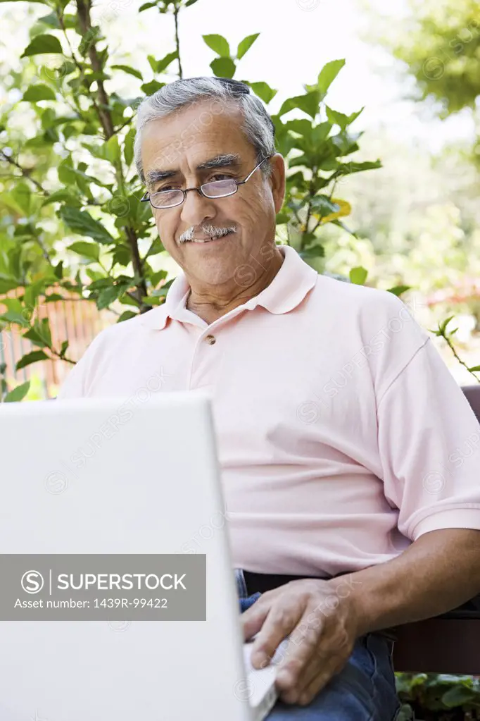 Senior man with laptop computer