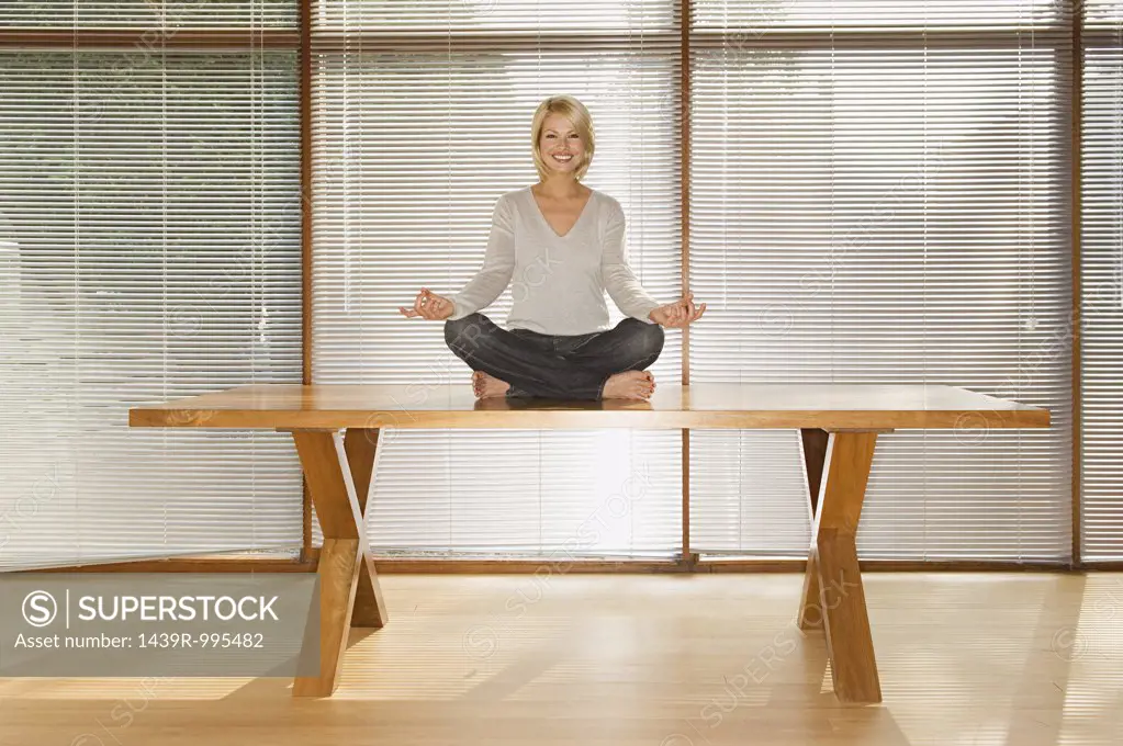 Woman meditating on table