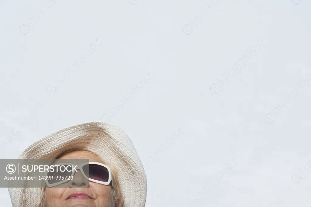 Woman wearing a sunhat and sunglasses