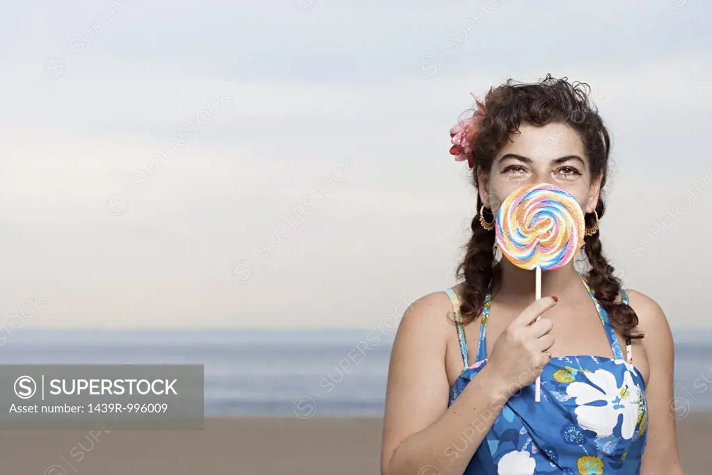 Woman on beach with lollipop