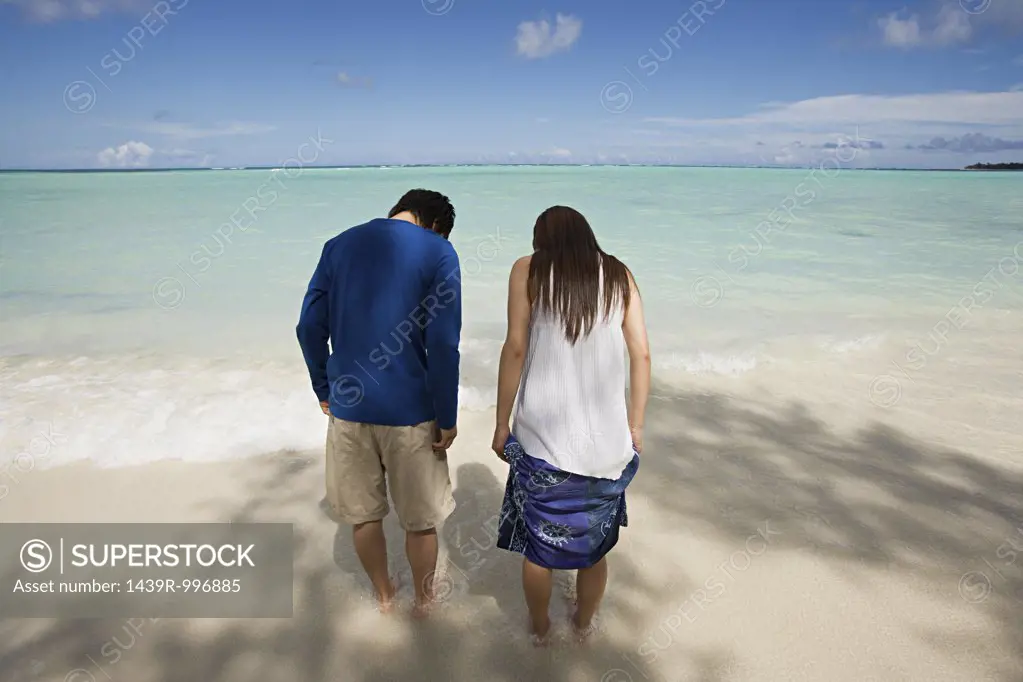 Couple paddling on beach