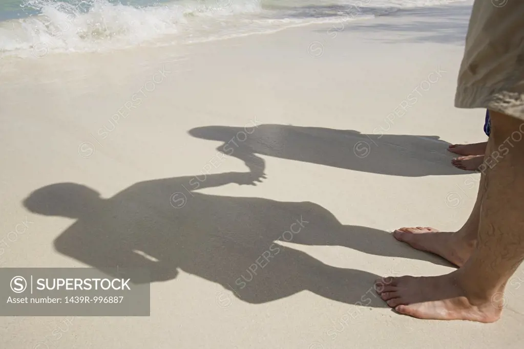 Shadows of couple on beach