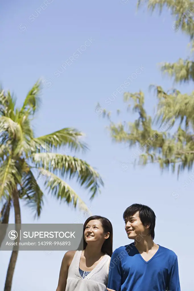 Couple by palm trees