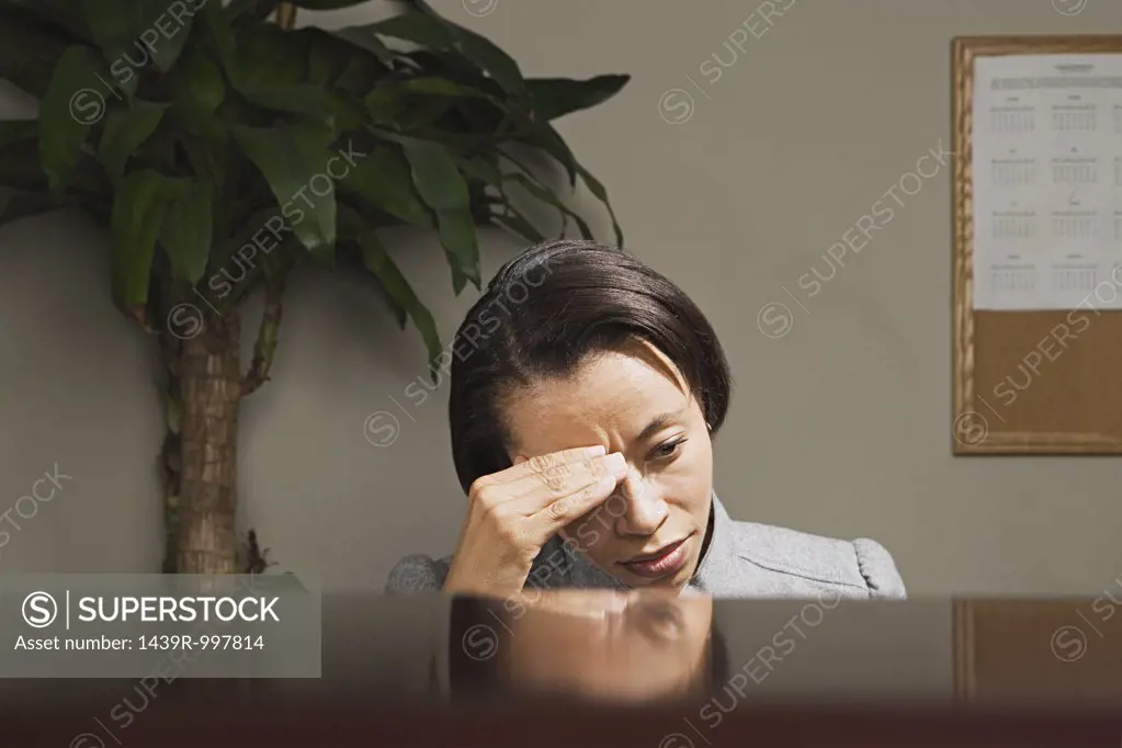 Businesswoman with her head in her hands