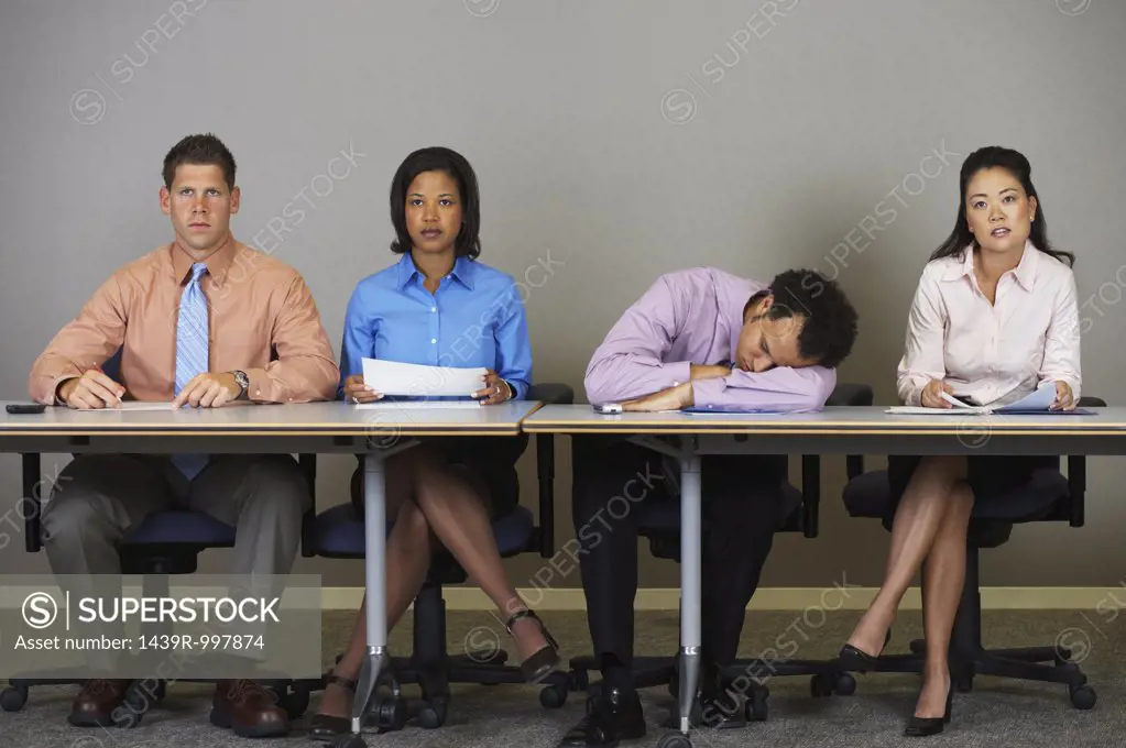 Businessman sleeping during a meeting