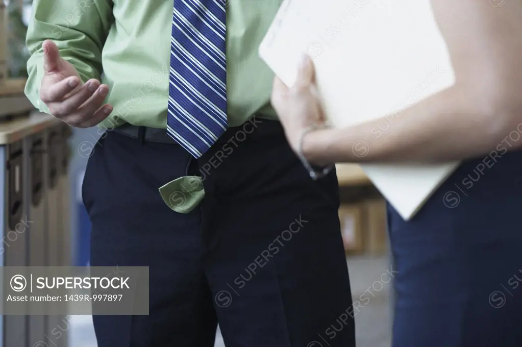 Businessman with his trouser zip undone