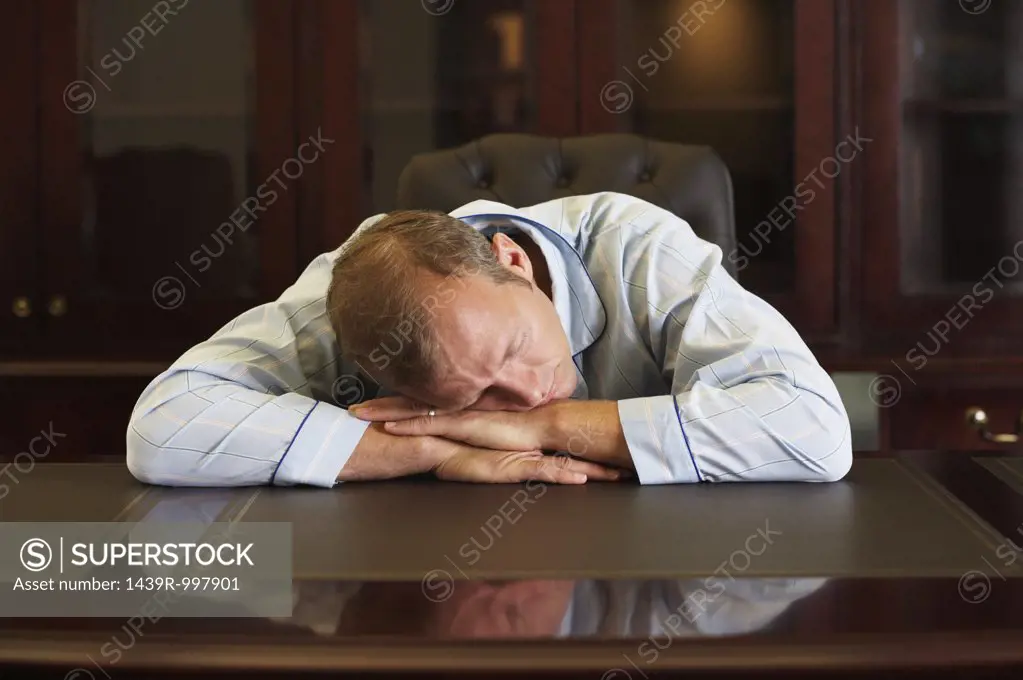 Businessman asleep at his desk
