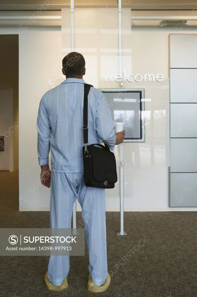 Businessman arriving at work in pajamas