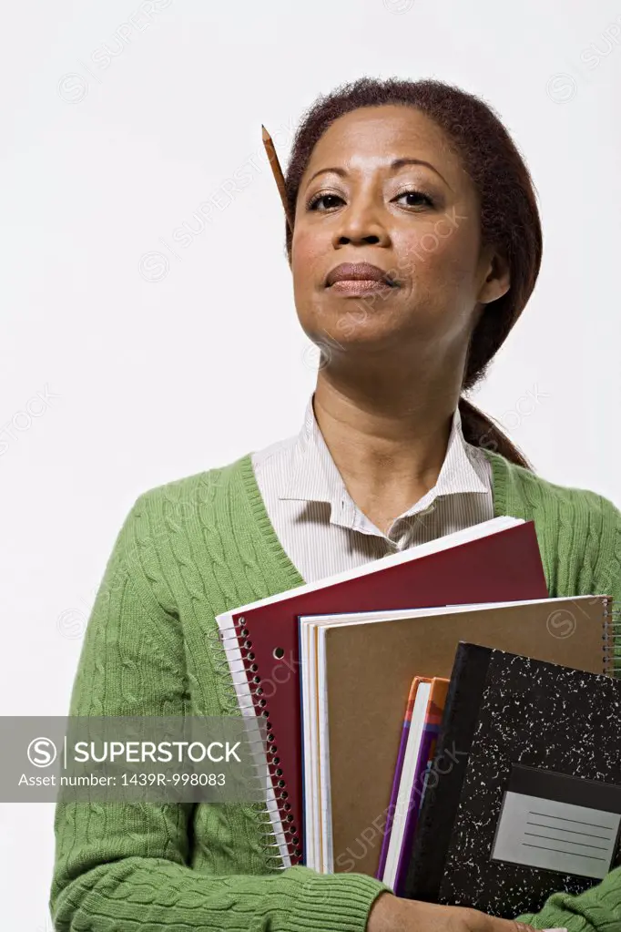 Portrait of teacher holding books