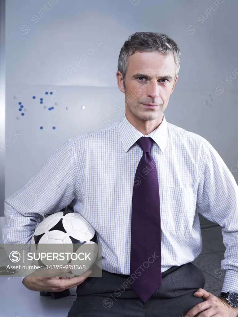 Businessman holding a football