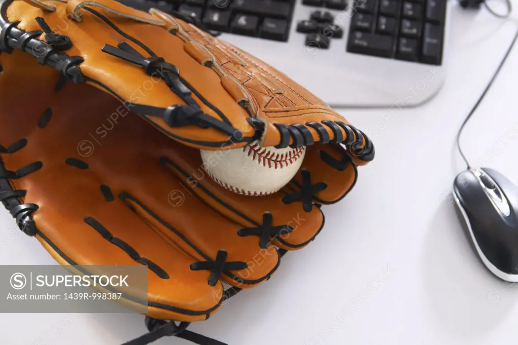 Baseball bat and glove on desk